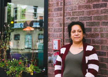 Elena standing outside Amore Coffee Shop in West St. Paul