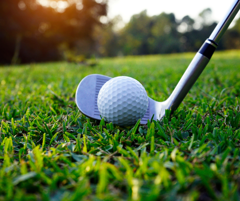 Image of golf club and golf ball on green