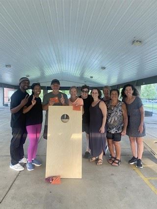 Image of adult bean bag league players posing for a group photo